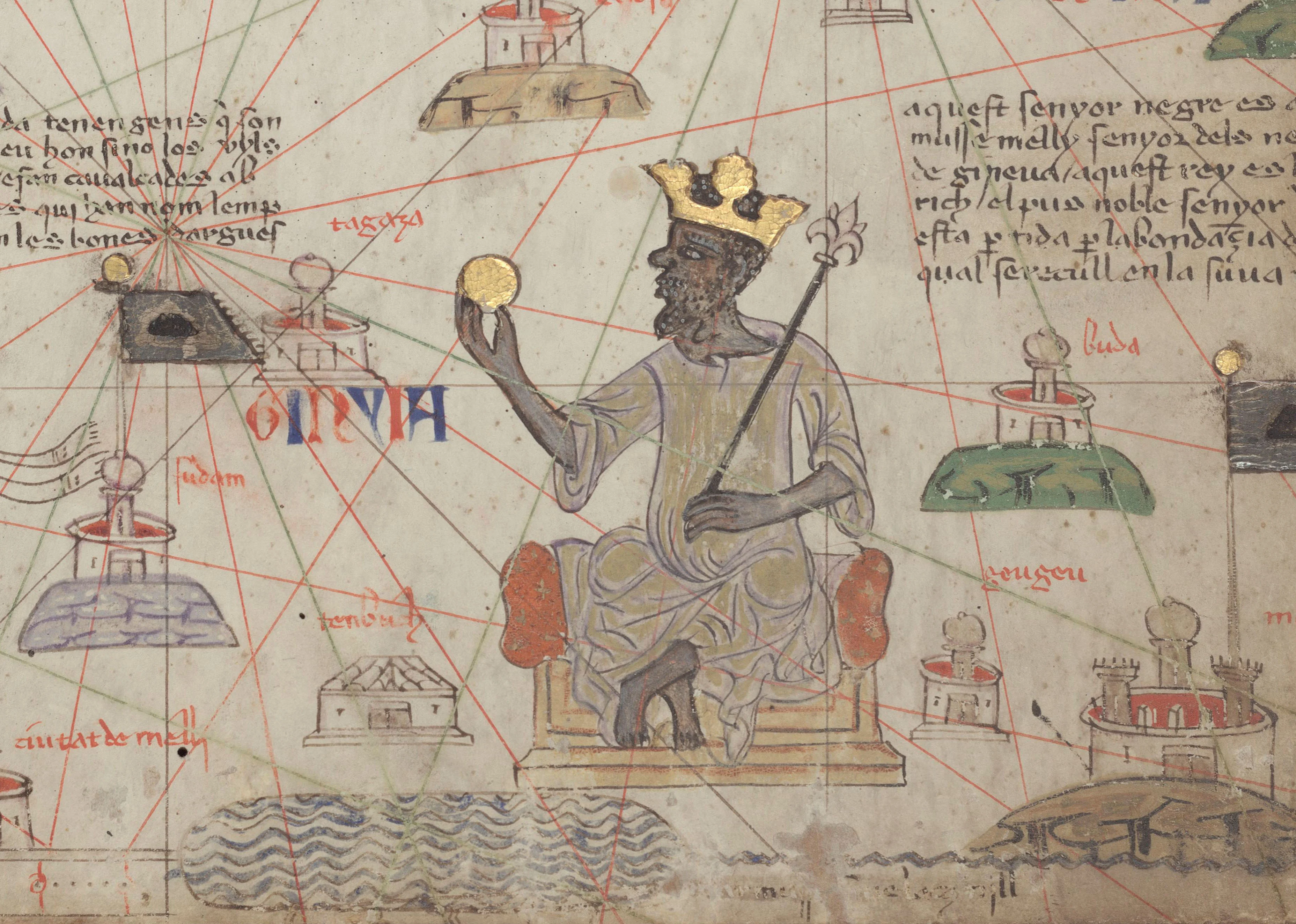 A detail of a medieval map on parchment: a bearded king with dark skin and a gold crown, seated on a throne, holds up a gold ball in one hand and a fleur-de-lis sceptre in the other, surrounded by drawn towns, red and green rhumb lines, a red-and-blue label reading GINYIA, and lines of Catalan script at the upper left and upper right